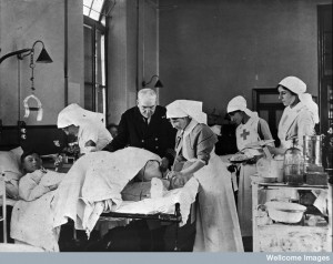 A doctor and nurses treat a wounded soldier in hospital